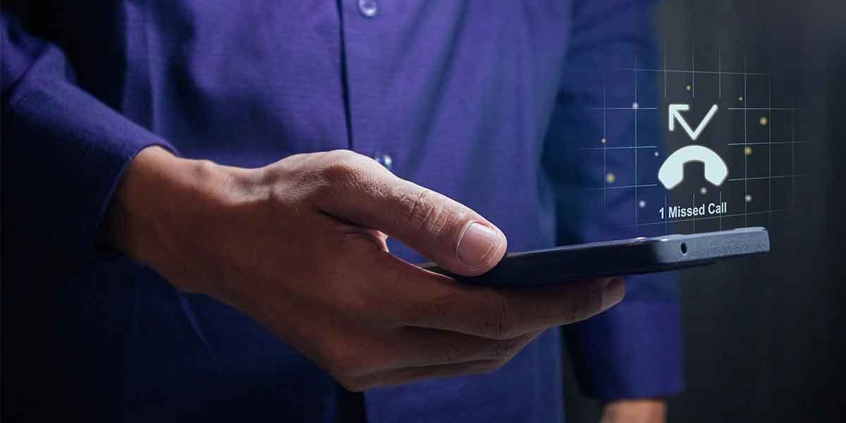 Man checks phone with missed call notification.