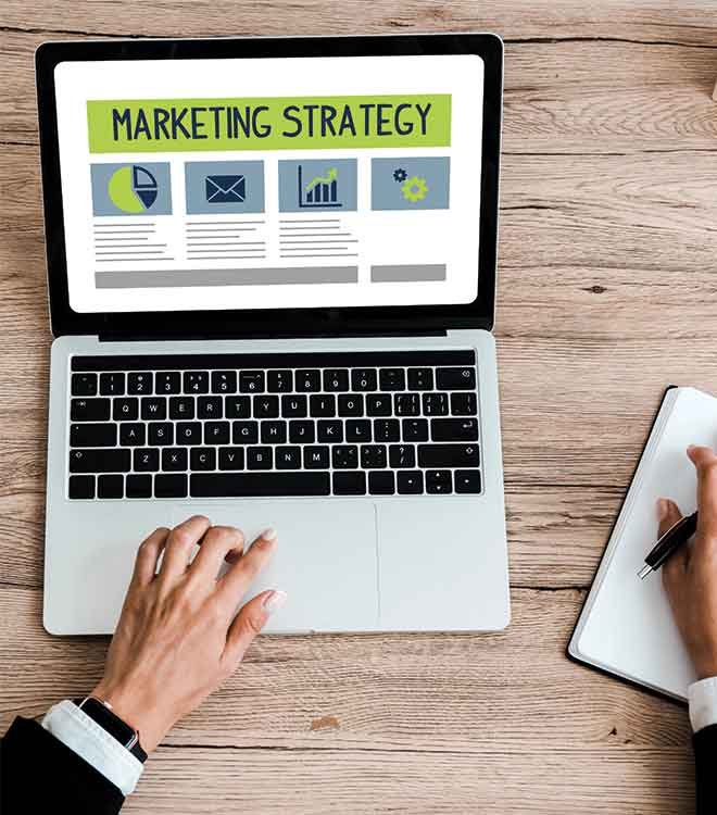 Person using laptop for marketing strategy planning.