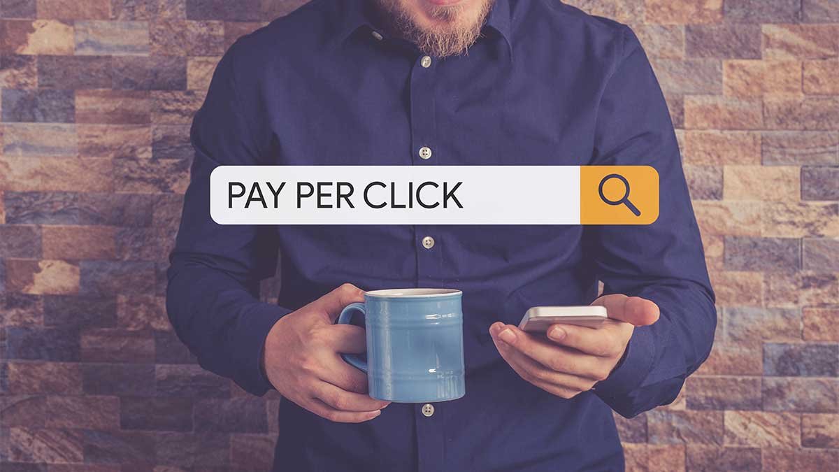 PPC for Restoration Companies Man holding phone, mug, with 'Pay Per Click' text. - PPC for Restoration Companies