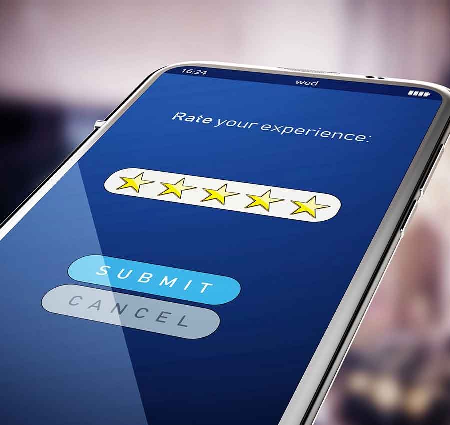 Smartphone screen shows five-star rating and submit button. Restoration Company Reviews