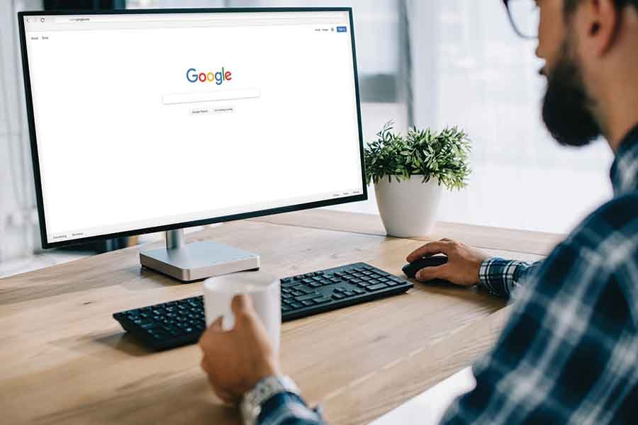 Person using Google search on desktop computer